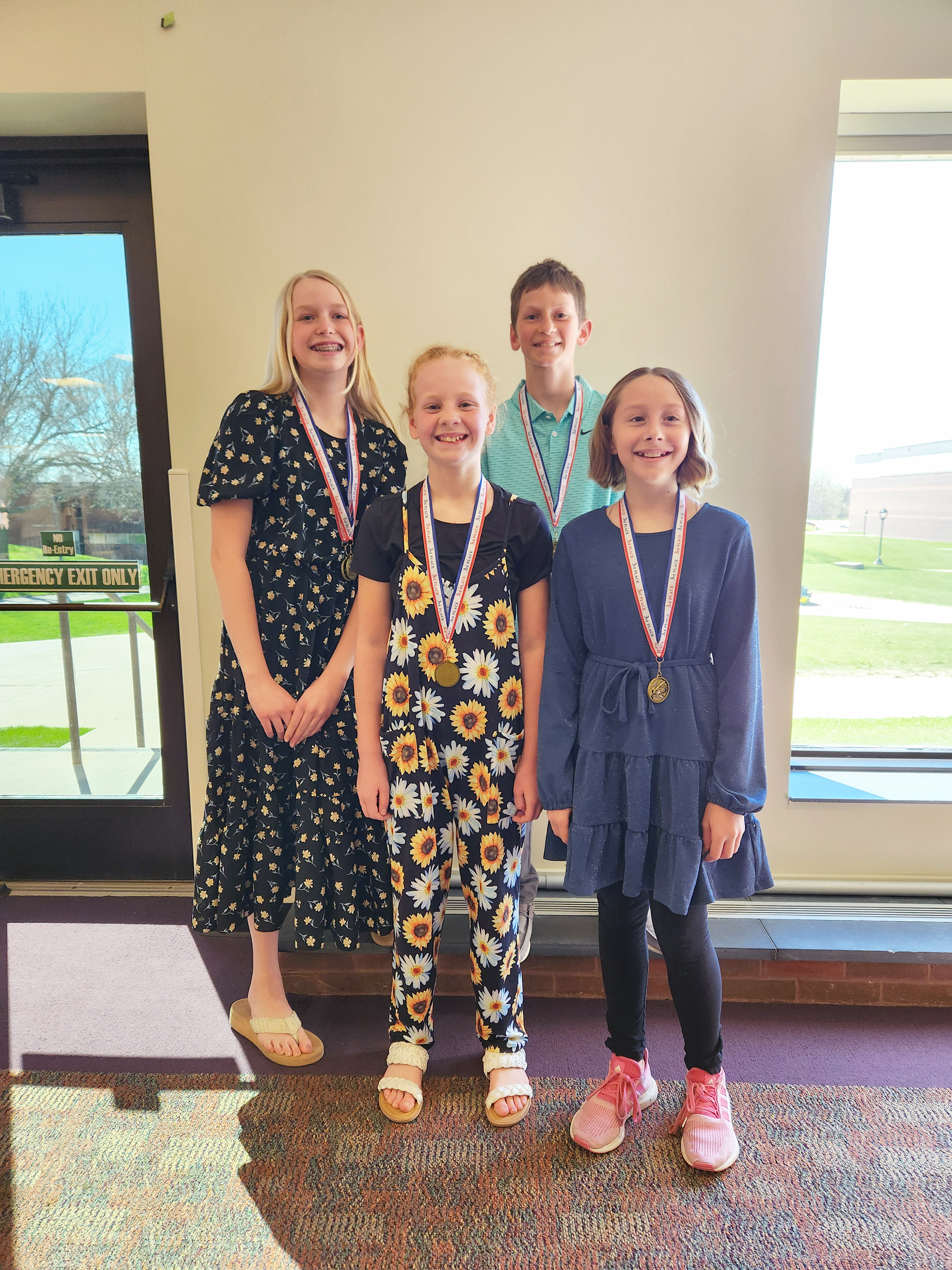 Four students from Hills-Beaver Creek earned medals Sunday at the 20th annual Creative Writing Contest awards ceremony. Pictured are (from left) Penni Moore, Londyn DeBoer, Bryce Metzger and Grace Prohl. Submitted Photo