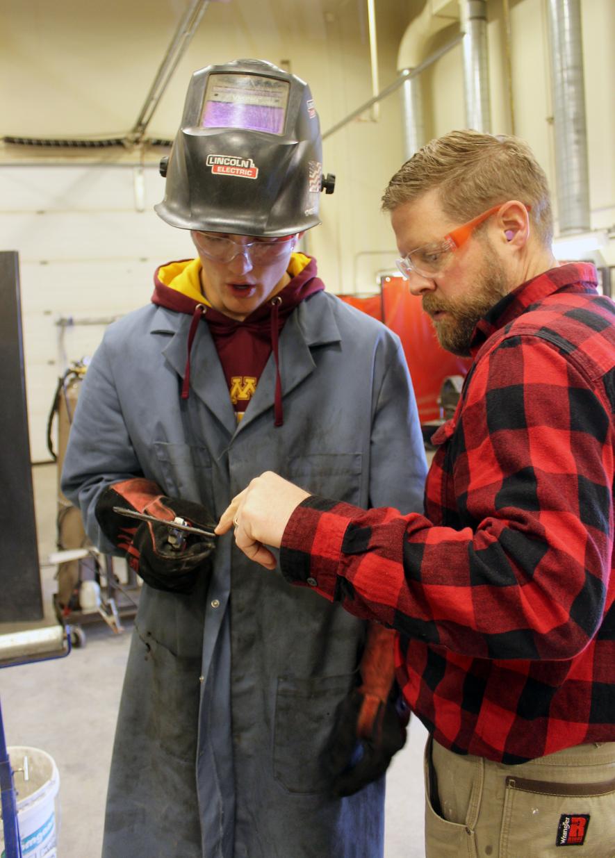 Blake Leenderts (left) and Power Mechanics instructor Chris Louwagie discuss the stick weld Leenderts completed. Mavis Fodness/Rock County Star Herald Photo