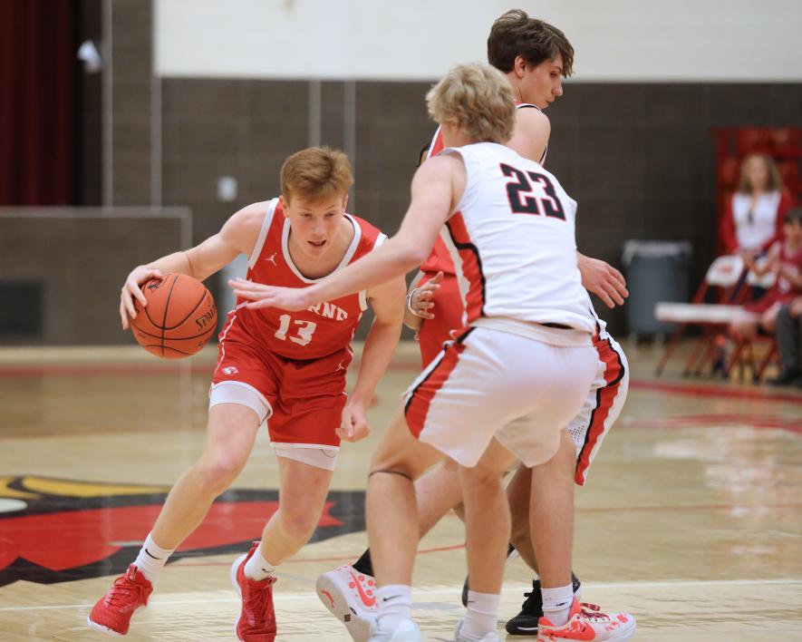 LHS sophomore Jaydon Johnson dribbles around a screen set by teammate junior Landon Ahrendt Tuesday, Jan. 9, in Luverne. The Cardinals fell to Worthington 71-68 in a close contest.