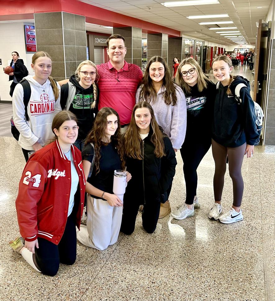 School resource officer Jeff Stratton (center) says he likes to spend time in hallways and common areas to connect with students in Rock County. On Monday he caught several students in Luverne to pose for a photo. Pictured are (front, from left) Bridget Thielbar, Khloe Visker, Amira Cowell, Hannah Cowell, Morgan Bonnett, Stratton, Kenedee Franken, Emma Deutsch and Marlee Nelson. Lori Sorenson/Rock County Star Herald Photo