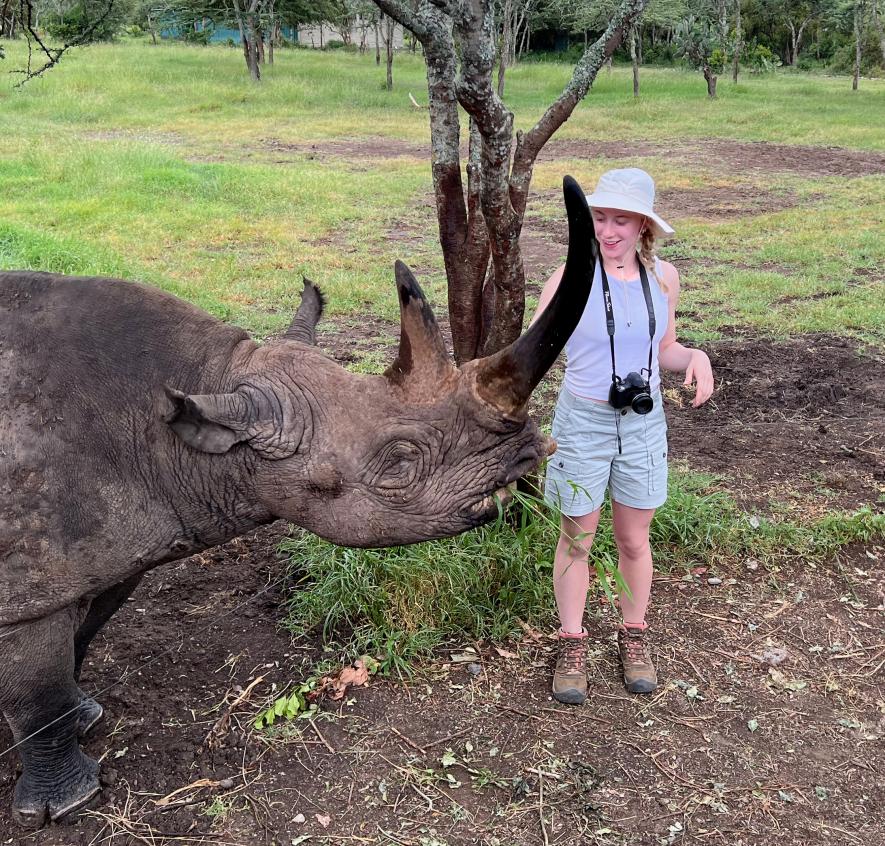 Sydney Biever feeds a blind black rhino in Africa