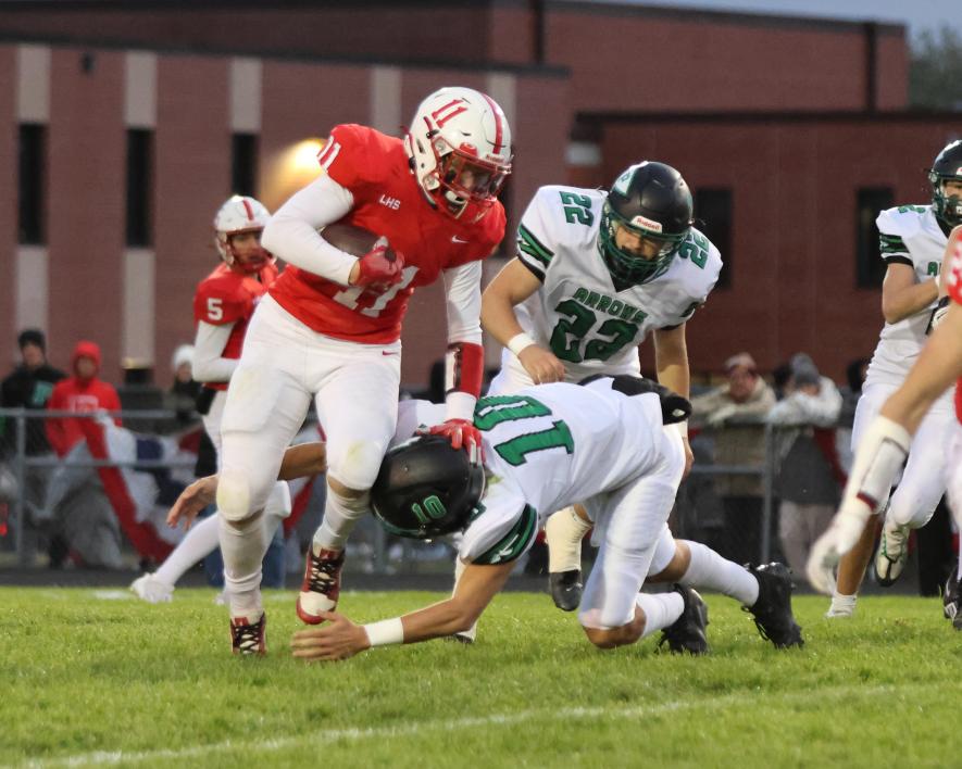 Greg Hoogeveen photo/1012 lhs fb1. Senior Elliot Domagala stiff-arms an Arrow defensive player for a few extra yards. LHS lost 3-0 Friday, Oct. 6, at home to Pipestone in the “Battle for the Axe” contest.