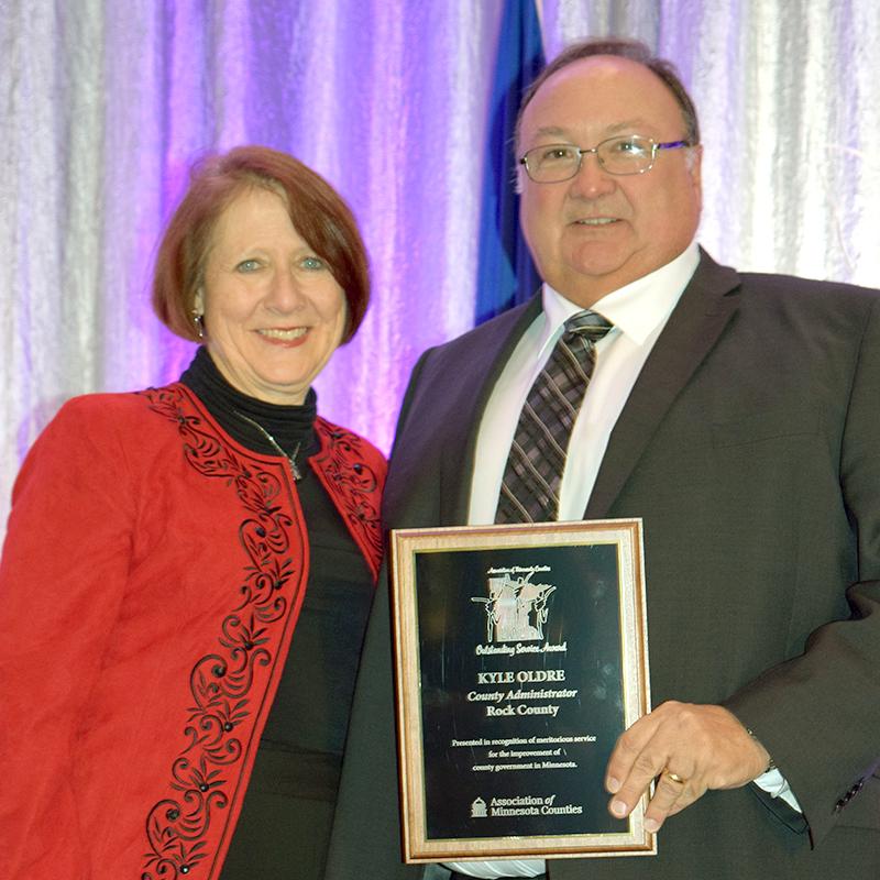 Kyle Oldre (right) was recognized with the Association of Minnesota Counties Outstanding Service award for his dedication to Rock County as its county administrator and emergency management director. He accepted the award during the AMC winter convention Dec. 5 in Minneapolis from AMC president Mary Jo McGuire. Submitted Photo