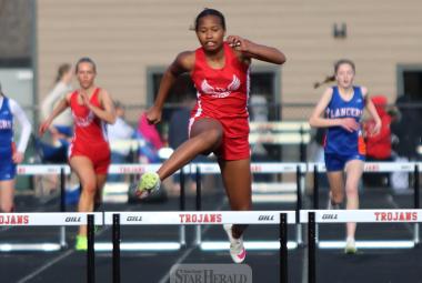 LHS freshman Reinha John hurdles her way to a first-place win in the 300-hurdles Thursday, April 25, in the Worthington track meet. She finished in a personal record time of 48.58.