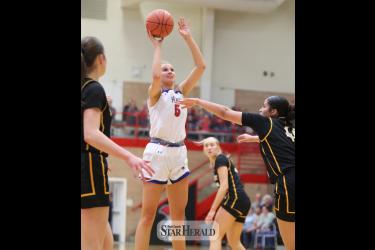 H-BC senior Lanae Elbers uses her height to go above the Eagles for a basket in the section quarterfinal game Friday, March 1, in Worthington.