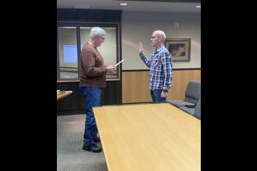 Rock County Commissioner Greg Burger (left) administers the oath of office to Rock County’s new veterans services officer Eric Oye Tuesday morning, May 7. Oye replaces David Haugom, who served in the position assisting local veterans for 14 years. Mavis Fodness/Rock County Star Herald Photo