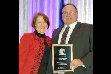 Kyle Oldre (right) was recognized with the Association of Minnesota Counties Outstanding Service award for his dedication to Rock County as its county administrator and emergency management director. He accepted the award during the AMC winter convention Dec. 5 in Minneapolis from AMC president Mary Jo McGuire. Submitted Photo