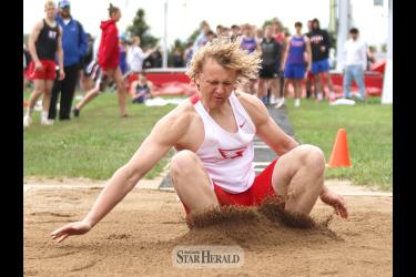 LHS senior Gavin DeBeer lands his long jump for a new school record jump of 21-8 1/4 Tuesday, May 7, at the True Team tournament in Luverne. 