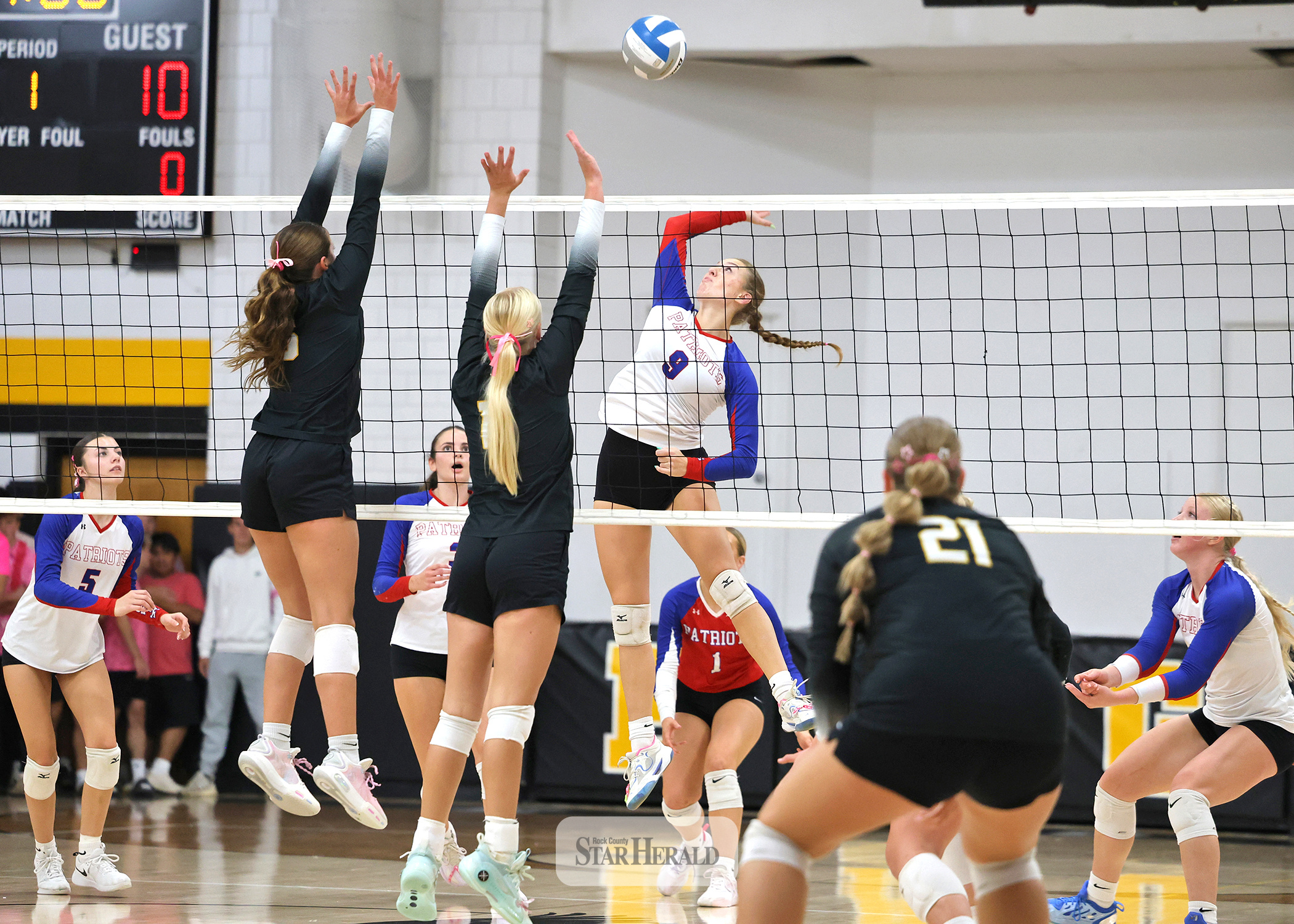 Greg Hoogeveen photo/HBCVB1 Patriots senior Ava Steinhoff prepares to spike the ball against Westbrook-Walnut Grove with teammates ready for any deflections at home Thursday, Oct. 8. The Chargers won the match against H-BC in three sets. 
