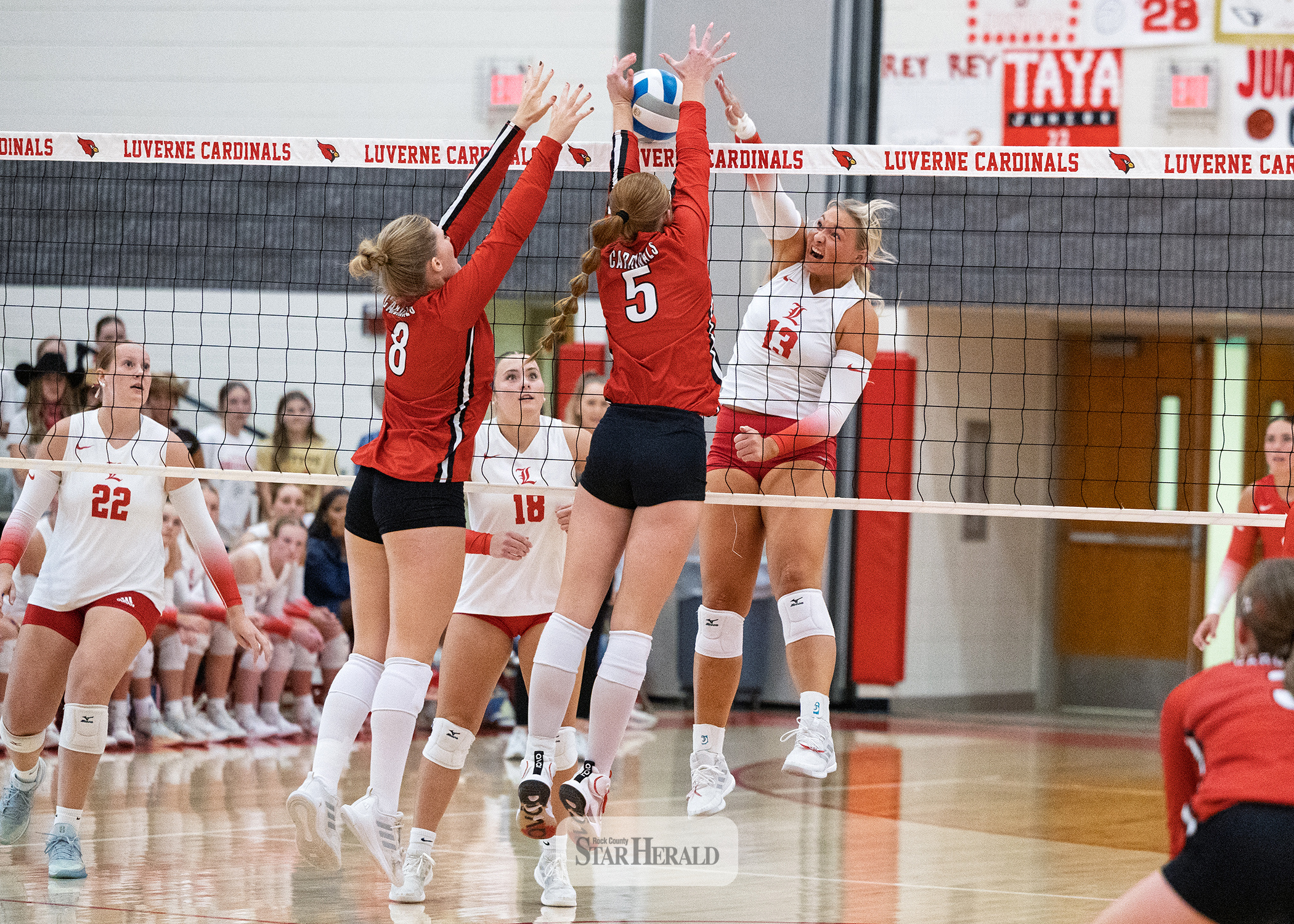 Greg Hoogeveen photo/0924LHSVB1 Cardinal senior Lexi Braun spikes the ball toward two Redwood Valley players at home Sept. 15 in Luverne. LHS fell 3-0.