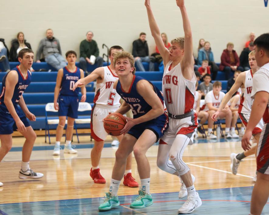 Patriot senior Riley Tatge looks to the hoop after grabbing a rebound under the basket. H-BC beat WWG 61-48 in Hills Friday, Jan. 5.