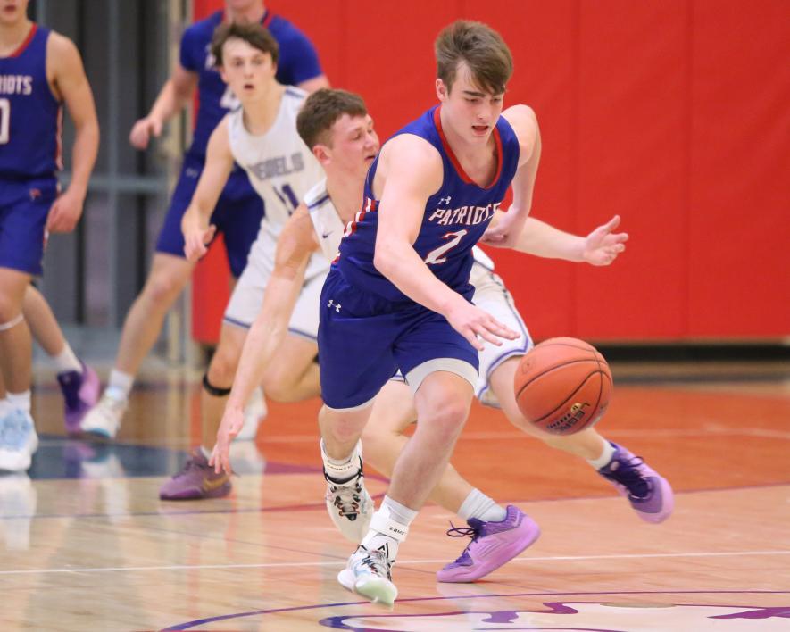 Junior Sawyer Bosch, No. 2, heads for the basket on a breakout past a Murray County Central player in Hills Saturday, Jan. 27. The Patriots beat the Falcons 57-48 in conference play.