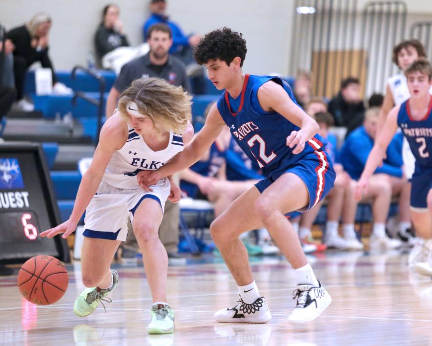 Sophomore EJ Wegener tries to muscle in on the ball against Elkton Monday, Feb. 12, in Hills. The Patriots beat the Elks 77-50 in the game.