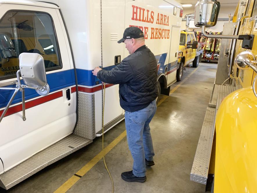 Hills Area Fire Department Chief Jared Rozeboom snaps the electrical cord into place Monday afternoon to the department’s 1996 Ford rescue truck and former ambulance. The rescue truck plays an important role in the department’s emergency calls as a transport of medical equipment and as support for the volunteer firefighters during each emergency call. In 2023 the rescue truck supported the department’s 61 calls. The department has owned the truck since 2011. Mavis Fodness/Rock County Star Herald Photo