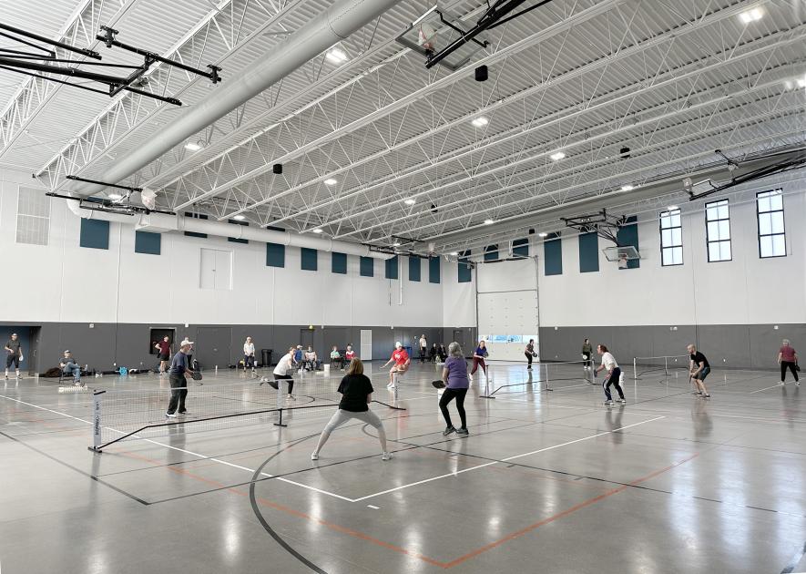 Five mornings a week, dozens of pickleball players gather in the National Guard Readiness Center assembly hall, which is divided into three courts to accommodate simultaneous games. Lori Sorenson/Rock County Star Herald Photo