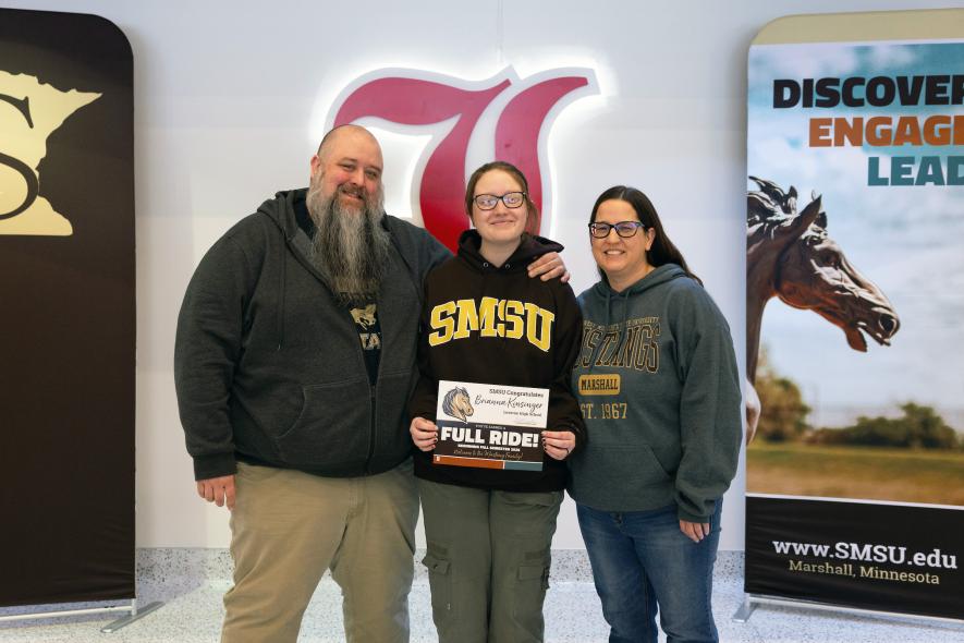 Photo courtesy of Southwest Minnesota State University Brianna Kinsinger (center) poses with the full-ride scholarship certificate from Southwest Minnesota State University, Marshall, with her parents, Shawn and Teresa Kinsinger.