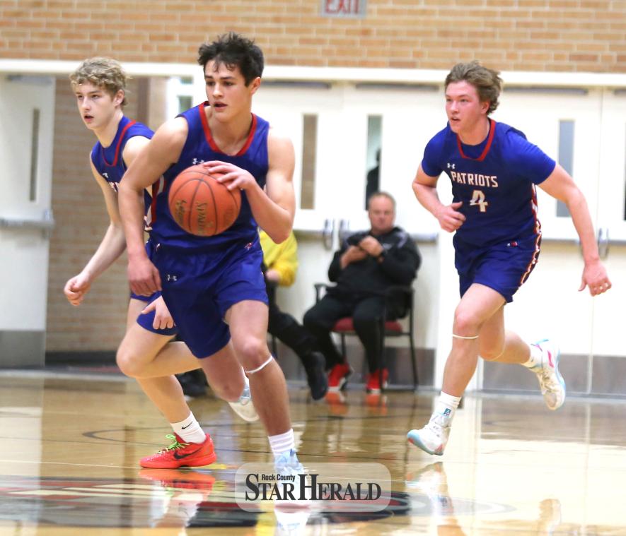 Eighth-grader Brodie Metzger (left), sophomore Micah Bush (middle) and junior Beau Bakken (right) push the ball up court without much pressure from the Coyotes in section play Saturday, March 2, in Worthington. The H-BC boys’ basketball team took down Heron Lake 64-44. 