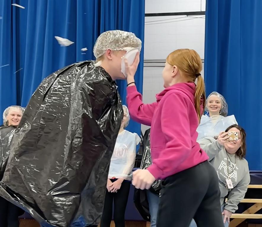 Charlie Wilsey plants a Reddi-wip pie in the face of Jackson Gacke Friday morning in the Hills-Beaver Creek Elementary gym. Lori Sorenson/Rock County Star Herald Photo