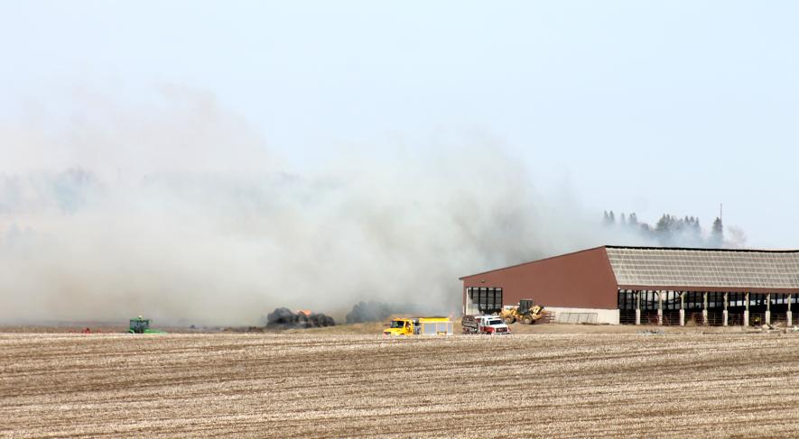 Fire departments from Luverne, Hills, Hardwick and Beaver Creek help contain fire to about 500 hay and cornstalk bales Saturday afternoon, April 6, at a farm west of Luverne. Southeast winds up to 55 mph pushed the fire into a nearby grass waterway and cornfield. Mavis Fodness/Rock County Star Herald Photo