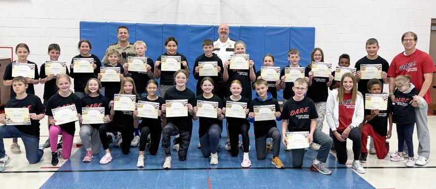 Pictured with certificates and wearing D.A.R.E. T-shirts are Kylar Cleveland, Afton Nuffer, Grace Prohl, Jordyn Rauk, Addison Sammons, Laney Top, Addy Westrum, Charlie Wilsey, Gage Spykerboer, Jase Vandeberg, classroom assistant Brynn Rauk, John Moeller, Sophie Gehrke, (middle) Kinley Dwire, Hollis Bartels, Madalyn Bonestroo, Grady Broesder, Fox Busswitz, Alize Dreamer, Jaden Gruis-Opheim, Zoey Huisman, Adriana Junge, Korbin Klarenbeek, Kenzie Kruger, Garpan Martens, Briggs Metzger, teacher Dylan Gehrke