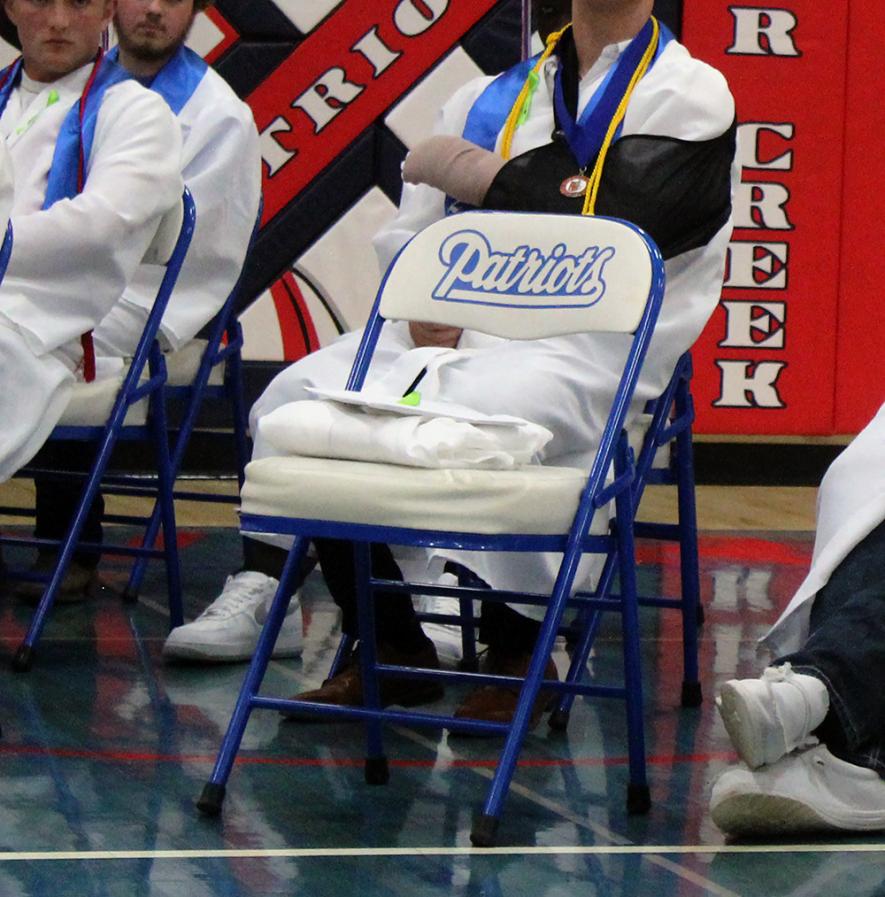 The late Ethan Erickson was remembered Friday night at the 60th Hills-Beaver Creek Secondary School Commencement with a cap and gown on an empty chair. Erickson died in 2019 when he was a seventh-grader. Mavis Fodness/Rock County Star Herald Photo
