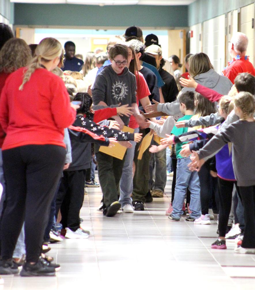 Kaitlin Conger leads the LHS Class of 2025 down an elementary school hallway. Mavis Fodness/Rock County Star Herald Photo