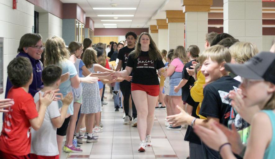 Morgan Ahrendt and JJ Shelton lead the Class of 2024 through the elementary cafeteria, where they were congratulated by fifth-graders. Mavis Fodness/Rock County Star Herald Photo
