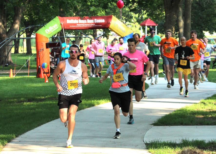 Blake Ziegler leads a pack of 5K runners from the starting line of Saturday morning’s Buffalo Days Run 4A Cause. Ziegler was the overall 5K winner with a 17:21 finish and sizzling 5:35 pace.