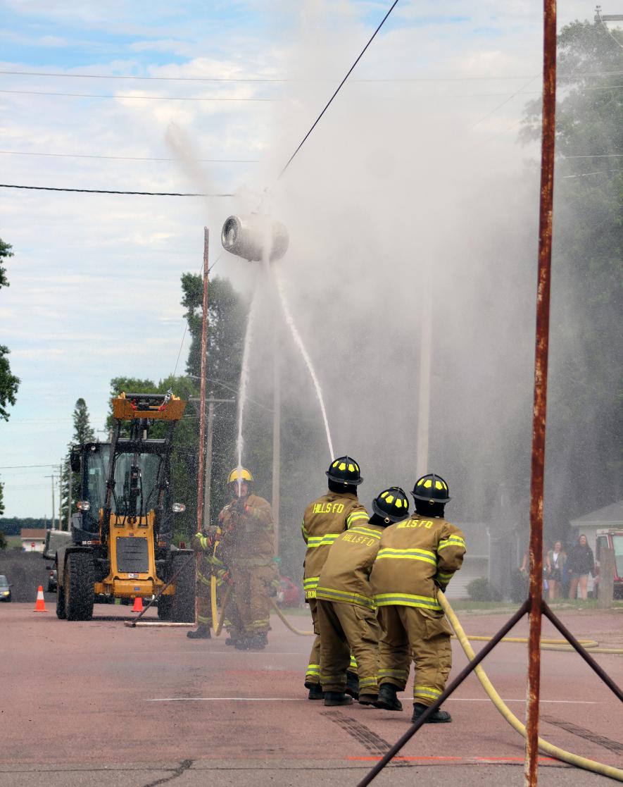 The Hills Fire Department team of Ty Bundeson, Sawyer Bosch and Logan Suzie take on the Ashton, Iowa, department in Round One of Fire Department Water Wars. Mavis Fodness/Rock County Star Herald Photo