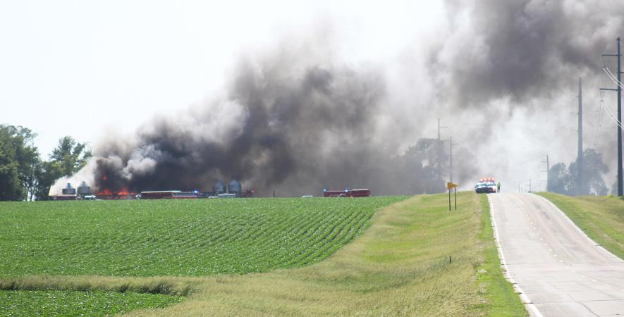 Smoke and flames are seen coming from the pig nursey barn Friday afternoon at the Ron and Lori Osenga acreage located five miles south of Jasper. Fire departments from Jasper, Luverne, Hardwick, Beaver Creek, Pipestone and Garretson contained the fire to the barn. The barn was a total loss. Mavis Fodness/Rock County Star Herald Photo