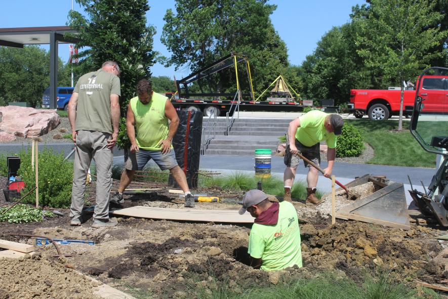 Steve Ellis (far left) and Oh’Landscapes workers Levi Beck, Gustavo Esteba and Junior Selseth set the concrete footings Monday afternoon for the tower that will hold the newly refurbished school bell, thought to have been at the former Luverne High School built in 1895. Mavis Fodness/Rock County Star Herald Photo