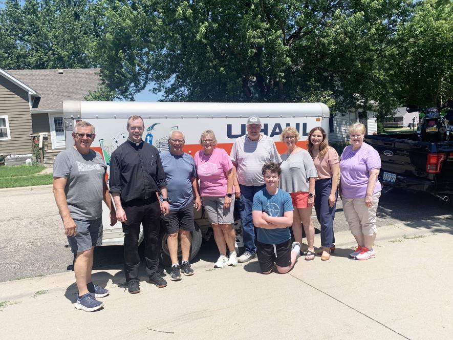 Parishioners assisted Father Joshua Miller move into the St. Catherine rectory July 1. Pictured are Pat Baustian (left), Father Joshua, Tom Nelson, Megan Nelson, Darrell Hemme, Joshua Luitjens (kneeling), Katie Baustian, Brandi Van Santen and Lynn Richters. Mavis Fodness/Rock County Star Herald Photo
