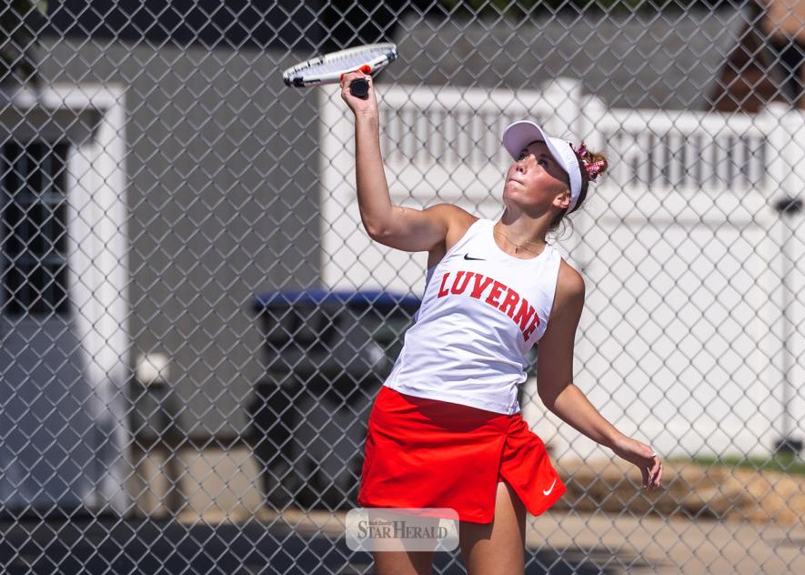 Cardinal senior Sophia Remme sends a serve over the net against Lac Qui Parle in the No. 1 singles match.