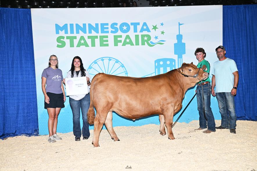 Evan Ossefoort exhibited the champion slick shorn steer at the Minnesota State Fair and earned an invitation to the annual Purple Ribbon Auction. Pictured is the Ossefoort family including (from left) Evan’s mother, Becky, sister Kaylie, Evan, and his father, Josh. Photo courtesy of U of M Extension