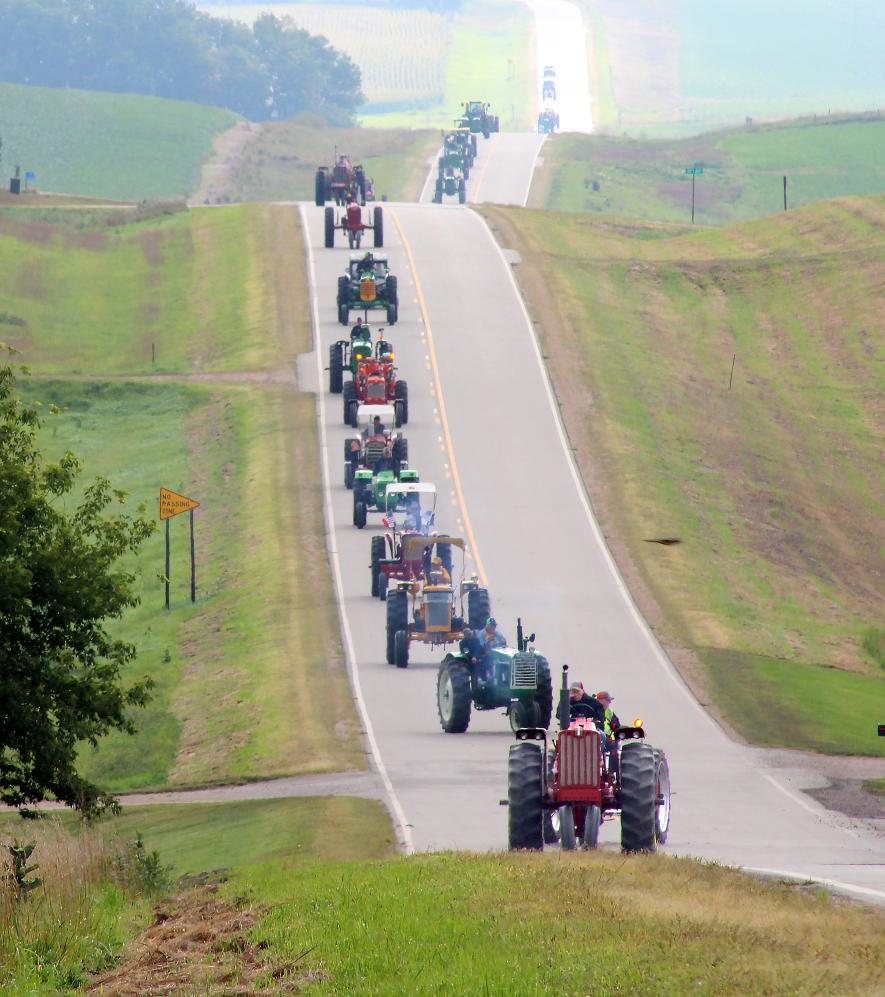 Dozens of tractors motor through and past the Bakken livestock feedlot Friday morning. Lori Sorenson/Rock County Star Herald Photo