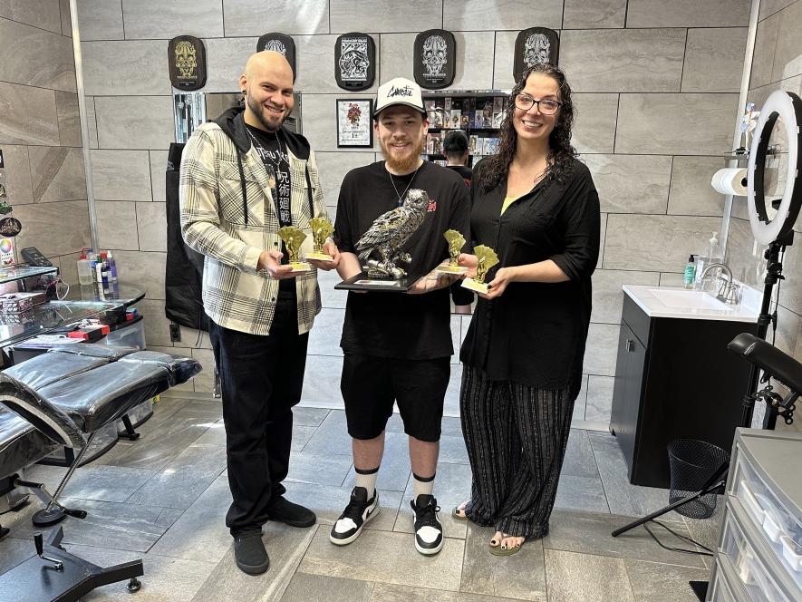 Conspiracy Tattoo operators Christina and Tony Perez are pictured with their friend and colleague, Donovan Conklin, who designed (and wears) one of the Tony’s winning tattoos.Rock County Star Herald Photo/Lori Sorenson