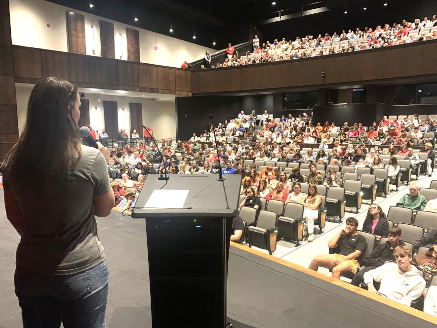 Caitlin Miller, a Luverne High School 2010 graduate, addresses seventh- through 12th-grade students Friday in the school’s performing arts center. Miller, who rowed across the Atlantic and Pacific oceans, encouraged students to be adventurous and not be afraid to try new activities or hobbies. Mavis Fodness/Rock County Star Herald Photo
