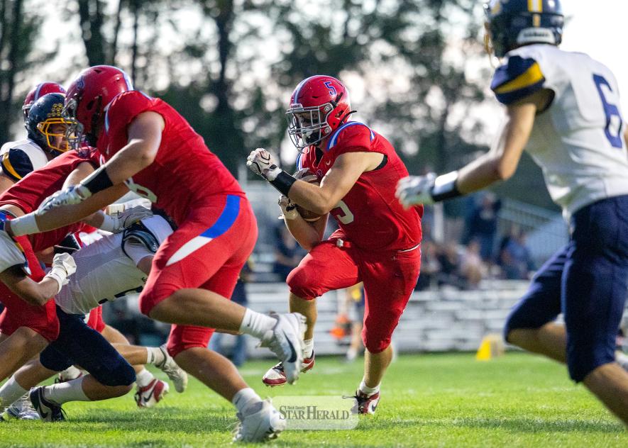 Greg Hoogeveen photo/0917HBCFB1 Patriots senior Riggins Rheault, No. 5, follows blockers to the end zone against Renville County West Friday, Sept. 11, at home. H-BC won the shortened game 38-6.  