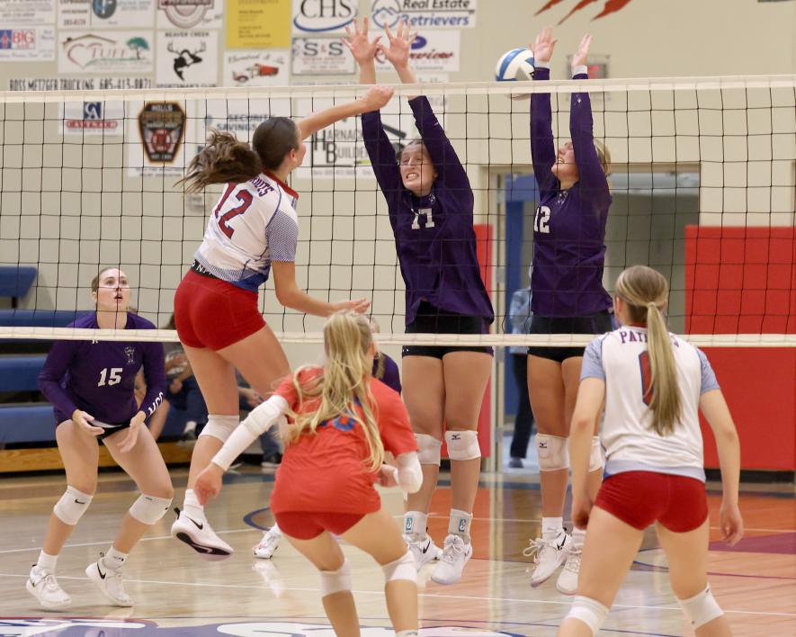 Freshman Olivia Deelstra drives the ball between two Murray County Central middle blockers Tuesday, Sept. 26, in Hills. The Patriots gave up three games to the Rebels in the H-BC homecoming volleyball game. Samantha McGaffee photo.