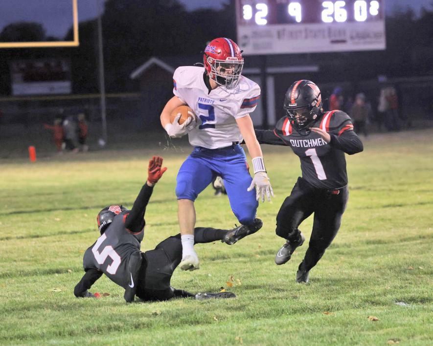 Samantha McGaffee photo/1012 hbc fb4. Junior Sawyer Bosch slips past two Edgerton defensive players Friday, Oct. 6, in Edgerton. Bosch posted 66 yards rushing and 38 yards receiving and one touchdown catch.