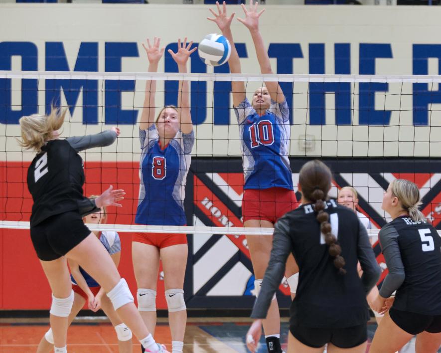 Junior Bailey Spykerboer and senior Lanae Elbers jump to block a shot from Heron Lake Tuesday, Oct. 3, at home. Heron Lake won the match in three sets. Greg Hoogeveen photo/1012 hbc vb5 