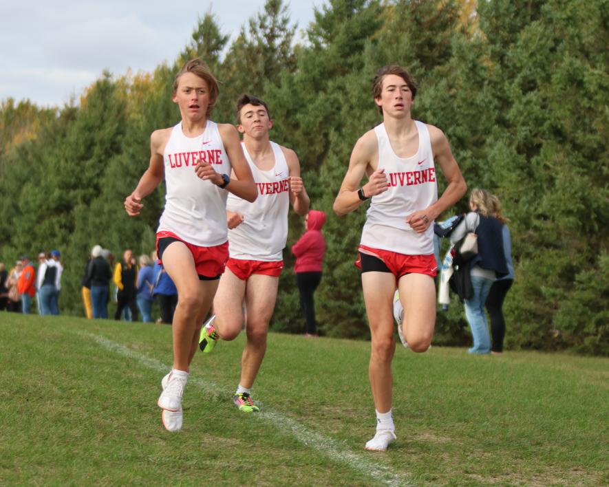 Greg Hoogeveen photo/1012 lhs xc3 Freshman Marcus Papik (left), junior Leif Ingebretsen and junior Sage Viessman reach the halfway point in the boys’ varsity 5,000-meter race Thursday, Oct. 5, in Luverne. Viessman finished in 11th place, Papik in 12th place and Ingebretsen finished in 16th place.