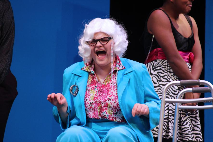 Great-aunt Millie (portrayed by senior Alex Perkins) gives a hysterical laugh at the reaction of her “nieces” to having their bodies waxed (which doesn’t include their heads). Mavis Fodness/Rock County Star Herald Photo