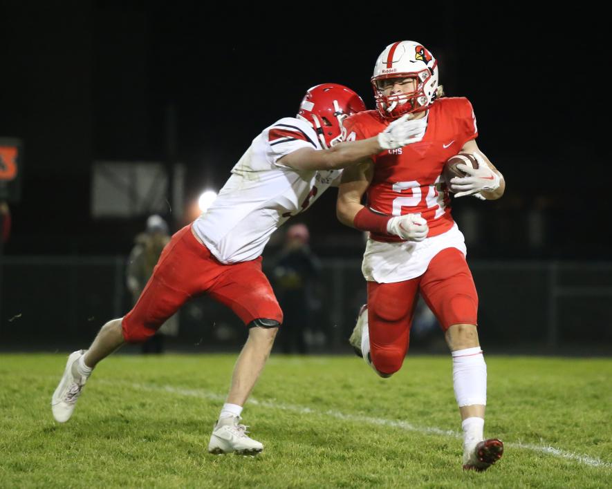Senior Gavin DeBeer braces for impact running the ball against Redwood Valley Wednesday, Oct. 18, in Luverne. The Cardinals won the final regular season game 33-21.