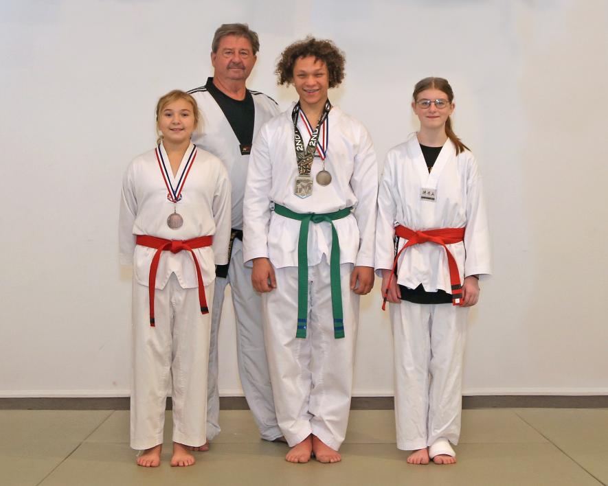Local Taekwondo students competed at the 39th Annual Midwest Taekwondo Championships Oct. 21. Placing for Luverne were (front row, from left) Alexandra Gangestad, Julian Dillard, Natalia Wieneke, (back) Grand Master Grieme.