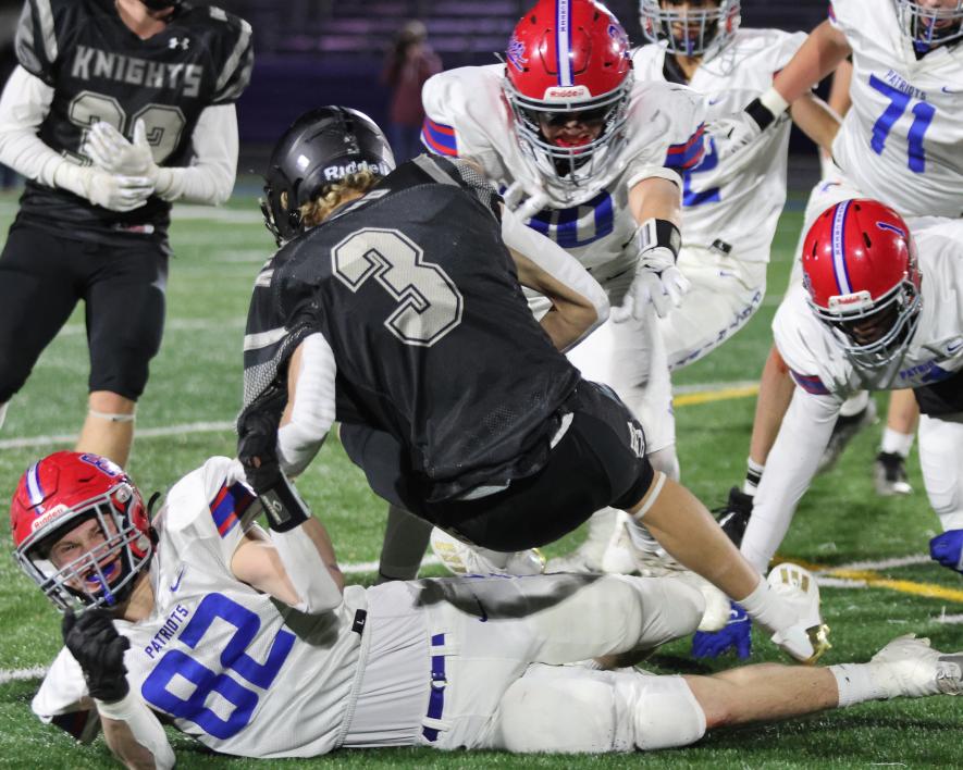 Patriots senior Riley Tatge (No. 82) and teammates bring down a Kingsland runner Thursday, Nov. 9, in 9-player state quarterfinal action. The Knights beat H-BC 26-14 to move on to the state action.