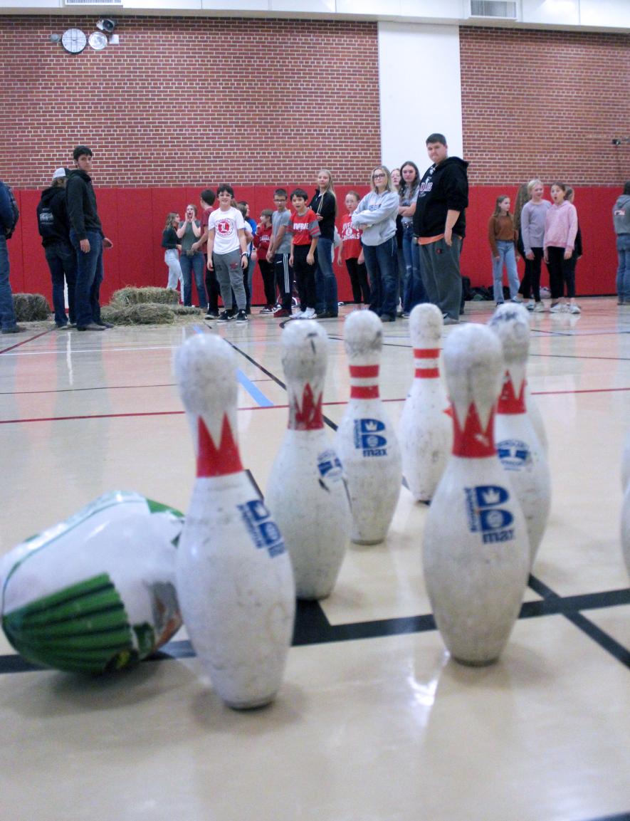 Owen Brockberg (center in white) takes his turn at turkey bowling. Mavis Fodness/Rock County Star Herald Photo