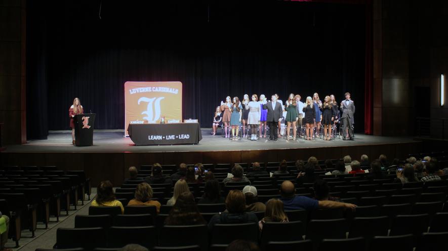 National Honor Society member Julia Hoogland (far left at podium) leads the pledge for the new inductees. Mavis Fodness/Rock County Star Herald Photo