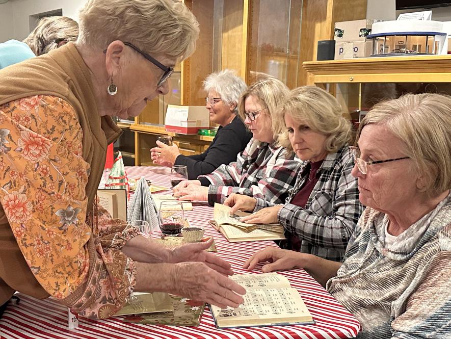Instructor Jeanne Bowron (left) helps Elaine Hemme get started with a hymn book. Also pictured (front to back) are Joan Kindt, Peggy Fransman and Deone Hemme. Lori Sorenson/Rock County Star Herald Photo