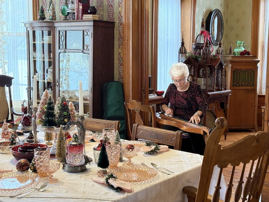 Musician Shirley Harrison plays Christmas music on a mountain dulcimer in the Hinkly House dining room for “Music at the Hinkly House” Saturday during Luverne’s annual Winterfest celebration. Lori Sorenson/Rock County Star Herald Photo